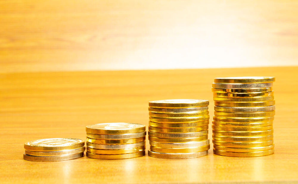 Gold coins stacked in ascending order representing Gold Investments for Long Term and steady financial growth.